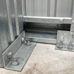 galvanised-steel-base-connection Galvanised steel shed base connection bolted to concrete showing structural bracket and anchor points