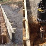 shed-foundation-preparation-nz Shed foundation trenching and post hole drilling showing site preparation and concrete layout for a steel shed build