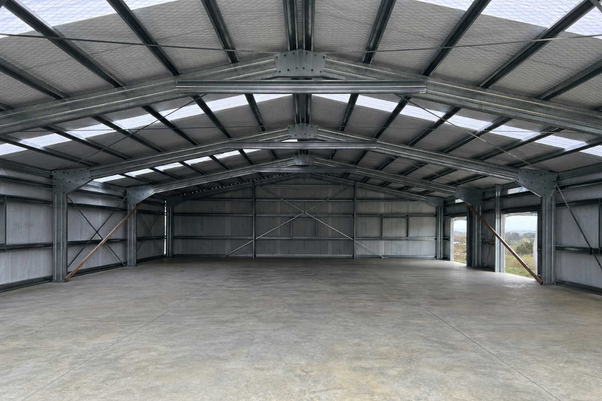 Bolted steel portal frame with completed wall and roof cladding