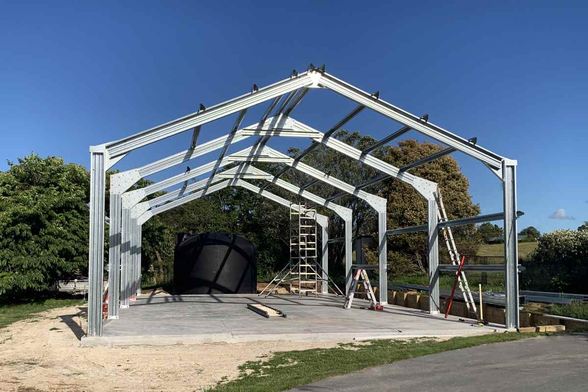 Steel shed frame under construction on a concrete slab in New Zealand