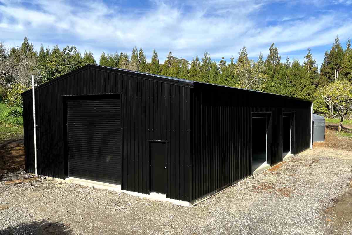 steel sheds nz Completed black steel shed with garage doors